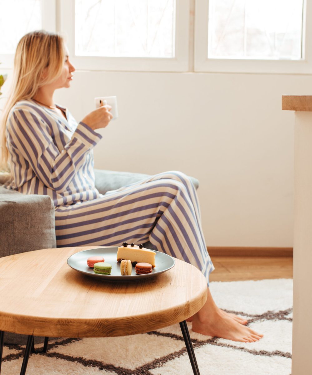 morning breakfast in bed and coffee. next to her is a woman in pajamas